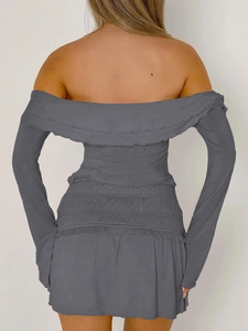 Detail view of grey off-shoulder long sleeve top with ruffled edges and ruched mini skirt
