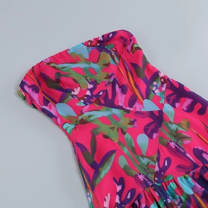 Detail view of pink tube dress featuring vibrant blue and purple floral print patterns
