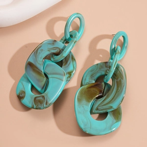 Detail of bohemian acrylic chain earrings with green and brown marble texture