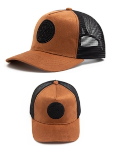 Detail view of suede mesh baseball cap with brown fabric and round black leather patch