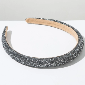 Detail of glittery grey padded headband showing sparkly sequin texture and soft fabric lining