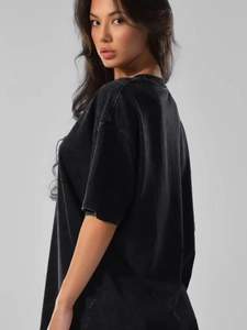 Detail of oversized washed black cotton T-shirt featuring vintage texture and drop shoulders
