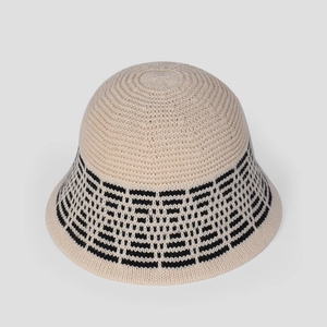 Detail view of cream knit bucket hat showing geometric pattern and fine texture