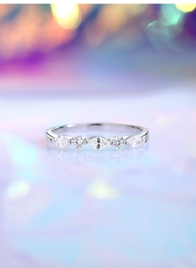 Macro shot of s925 silver ring featuring five marquise and round cut cubic zirconia stones