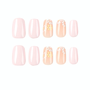 Pink press-on nail set featuring ten short square pieces with yellow daisy floral art