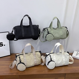 Minimalist nylon cylindrical shoulder bags in four colors with detachable round coin purses