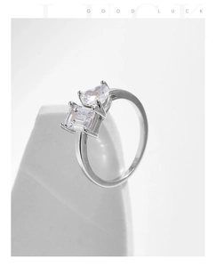 Macro detail of S925 silver ring featuring emerald-cut and heart-shaped crystals