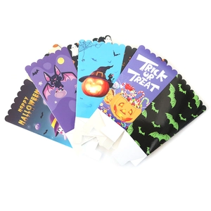 Halloween paper treat boxes with pumpkin and bat patterns in a scalloped edge design
