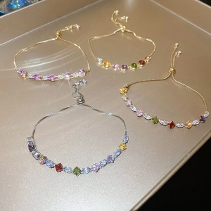 Detail view of colorful zircon adjustable bracelets in gold and silver finish