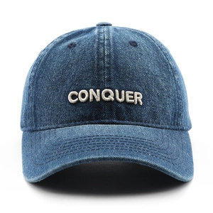 Retro denim baseball cap featuring white embroidered CONQUER text and washed blue finish