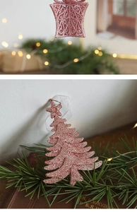 Pink glitter star and Christmas tree ornaments with soft holiday lighting