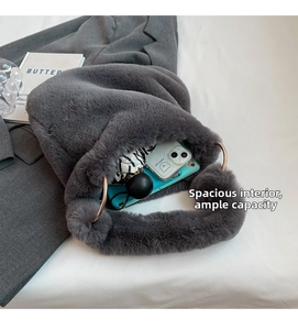 Detail view of grey faux rabbit fur bag with golden ring handle and internal capacity