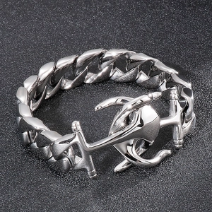 Macro detail of silver punk anchor clasp on heavy duty Cuban chain bracelet