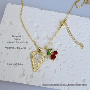 Macro shot of 18K gold plated heart and cherry pendants with AAA+ cubic zirconia