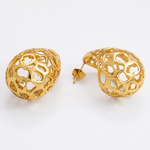 Detailed macro view of gold hollow spiral earrings with intricate mesh texture