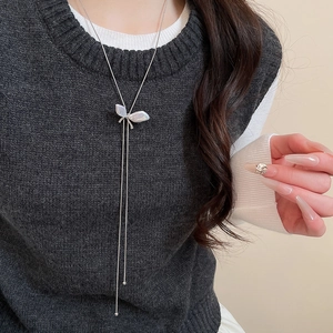 Macro shot of butterfly pendant necklace with elegant mother of pearl shell and silver tassels