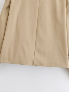 Detailed back view of khaki trench coat showing professional stitching and hem craftsmanship
