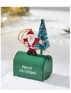 Detailed view of red Santa Claus and green Merry Christmas mailbox on snowy scene
