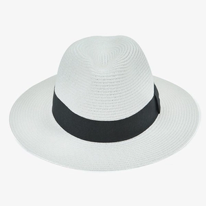 Detailed texture of white woven straw panama hat with black ribbon decoration