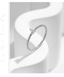 Macro shot of s925 silver beaded ring featuring a sparkling heart-shaped moissanite stone