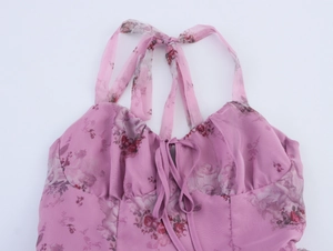 Detailed close-up of floral organza halter neck dress with pleated chest design
