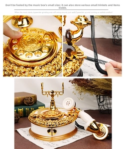 Detail of vintage telephone music box featuring gold dial and heart-shaped drawer storage