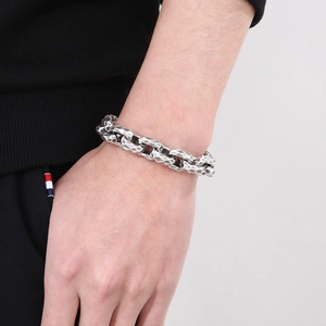 Close-up of vintage hammered texture and distressed silver finish on men's steel bracelet