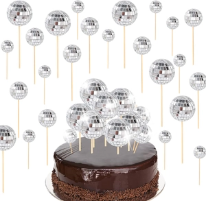 Close-up of silver disco ball cake toppers in various sizes on wooden sticks
