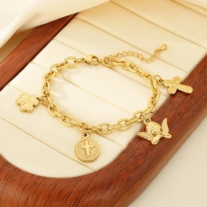 Gold plated stainless steel charm bracelet with cross, angel and clover on jewelry stand