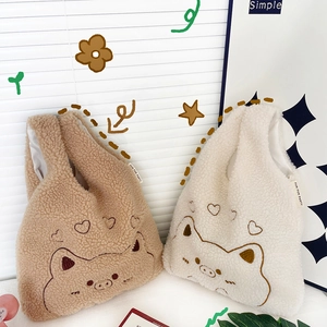 Cute embroidered plush fleece wrist bags in beige and brown with cartoon pig patterns