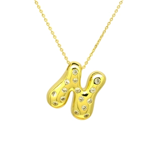 Macro shot of gold bubble initial N pendant necklace with sparkling zircon pavé