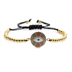 Adjustable golden copper bead bracelet with cubic zirconia evil eye charm on black cord
