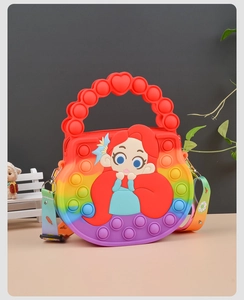 Detail of mermaid silicone pop-it purse with rainbow strap and heart-shaped red handle