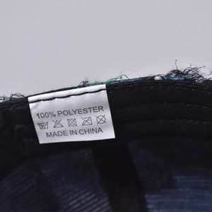 Macro shot of the baseball cap inner lining with 100% polyester material label