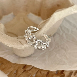 Macro shot of silver multi-layer twisted rope ring with adjustable industrial design