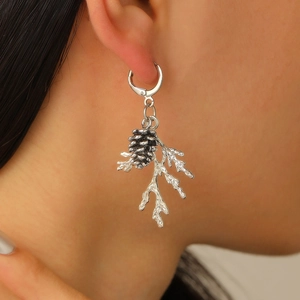 Close-up of vintage pine cone and branch earrings in antique silver finish on model