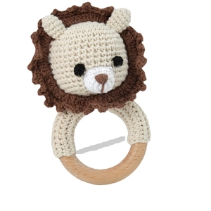 Handmade crochet lion baby rattle with a natural wooden ring and soft cotton knit
