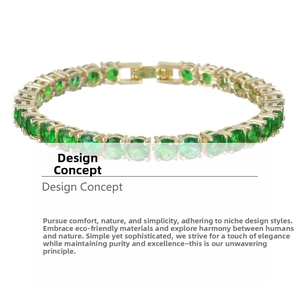 Close-up of gold-plated tennis bracelet with round-cut emerald green zircons and folding clasp