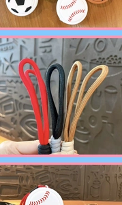 Close-up of colorful braided paracord lanyard loops with sports-themed keychain charms