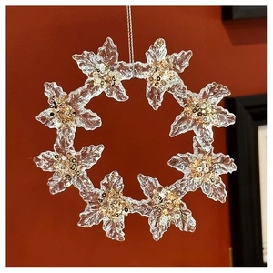 Macro shot of transparent acrylic snowflake ornament with gold and silver glitter accents