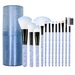 12-piece glitter blue makeup brush set with gradient bristles and matching storage cylinder