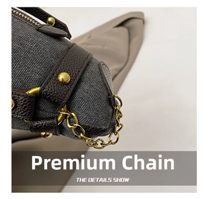 Detailed macro shot of premium golden metal chain and textured litchi leather edging