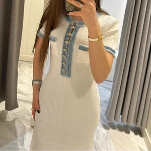 Slim fit white knit dress with blue denim trim and decorative gold buttons shown on model