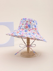 Detail of floral bucket hat with blue and orange flowers and tied chin strap bow