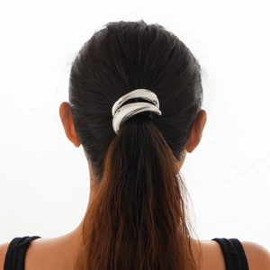 Detail of silver metallic double arc hair cuff on ponytail with smooth mirror finish