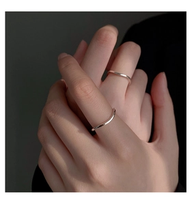 Close-up of minimalist S925 sterling silver wavy and thin stackable rings on a model