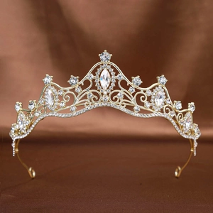 Macro shot of bridal crown featuring golden filigree patterns and sparkling rhinestones