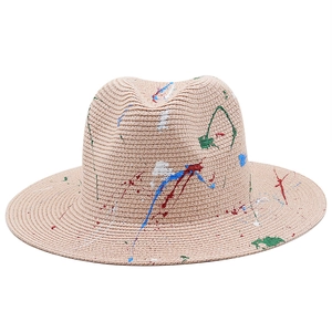 Macro detail of hand-painted colorful paint splatters on straw fedora panama hat texture