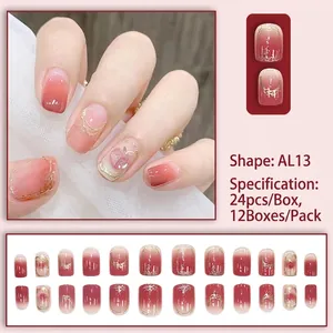 Pink gradient press-on nails with gold foil and heart accents in almond shape AL13