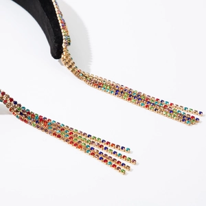 Macro view of colorful rhinestone tassels on a black velvet headband for women